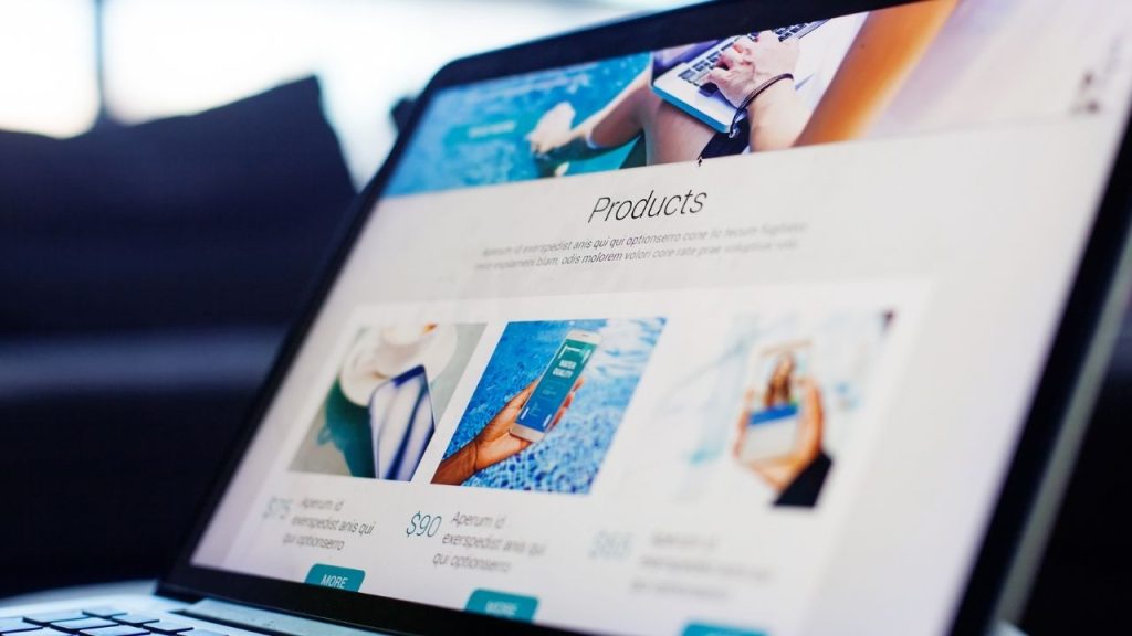 laptop displaying a "Products" page with images and pricing details.