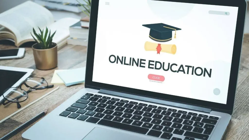 Laptop displaying the words "Online Education" with an academic cap icon.